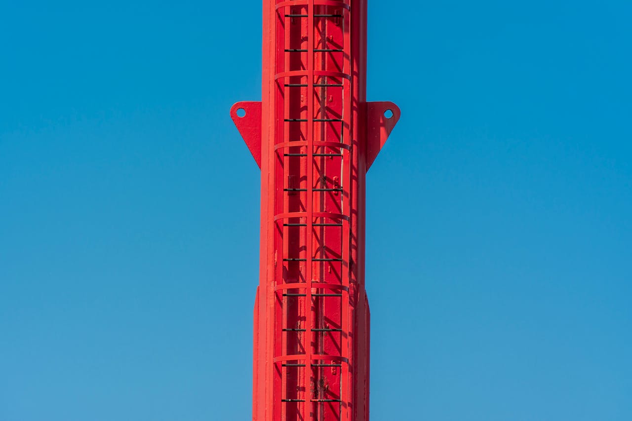gallery-1 Close-up of a red tower structure against a bright blue sky in Hoek van Holland.