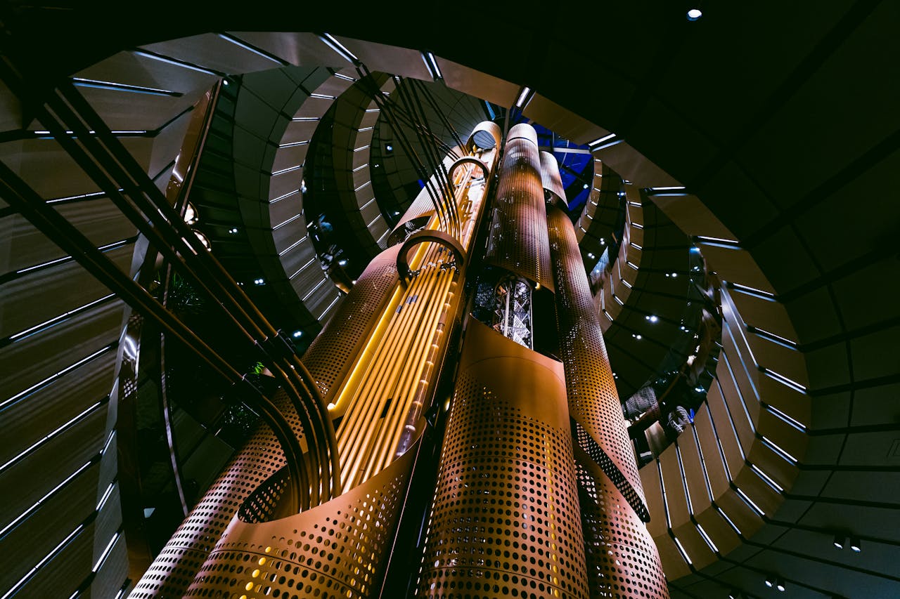 hero-img-02 Low angle view of a modern futuristic elevator interior in Chicago, showcasing innovative architecture.