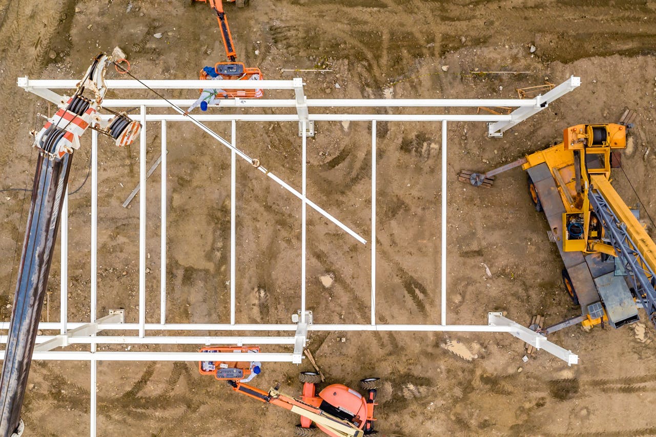 about-01 Top view of pumpjack and elevating crane setting heavy metal structure in sandy ravine